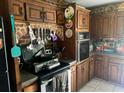 Rustic kitchen with wooden cabinets, brick accents, and functional cooking setup at 805 Horne St, Saint George, SC 29477