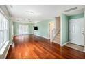 Spacious living room boasts hardwood floors, natural light, and an open floor plan at 8739 Grassy Oak Trl, North Charleston, SC 29420