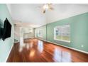Well-lit living room features hardwood floors, neutral walls, and vaulted ceiling at 8739 Grassy Oak Trl, North Charleston, SC 29420