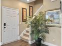 Welcoming entryway with hardwood floors, staircase, and stylish decor art at 8810 Gilston Ln, North Charleston, SC 29420