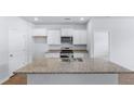 Modern kitchen with stainless steel appliances, granite counters and white cabinets at 1050 Forrest Creek Dr, Summerville, SC 29483