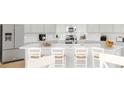 Kitchen island with seating and stainless steel refrigerator at 1051 Tea Time Dr, Summerville, SC 29485