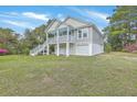 Inviting exterior featuring a raised foundation with garage parking and convenient stairway access to the living space at 1224 Midvale Ave, Charleston, SC 29412