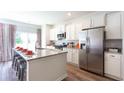 Stylish kitchen features stainless steel appliances, granite counters, and ample cabinet space at 124 Haventree Ct, Summerville, SC 29486