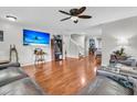 Spacious living room with hardwood floors, a ceiling fan, and a large TV for entertaining guests at 1252 Wild Goose Trl, Summerville, SC 29483