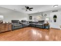 Cozy living room showcasing a comfortable sectional sofa, hardwood floors, and natural light from the window at 1252 Wild Goose Trl, Summerville, SC 29483