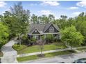 Charming home exterior featuring manicured landscaping, a patterned driveway, and a well-maintained lawn at 126 Balfour Dr, Charleston, SC 29492