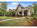 Inviting front exterior showcases a covered porch, well-kept lawn, and lush landscaping, perfect for curb appeal at 126 Balfour Dr, Charleston, SC 29492