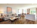 Stylish living room featuring modern decor and light-filled dining area at 136 Haventree Ct, Summerville, SC 29486
