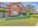 Traditional brick townhouse with manicured lawn and walkway to entrance at 1421 Dove Run Dr # C, Charleston, SC 29412