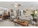 Cozy living room featuring neutral tones, a ceiling fan, and ample natural light for a welcoming atmosphere at 181 Commons Way, Goose Creek, SC 29445