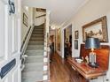 Welcoming entryway featuring hardwood floors, stairs, and elegant decor at 21 Rutledge Ave, Charleston, SC 29401