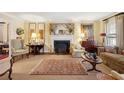 Cozy living room with a fireplace, decorative rug, and classic furnishings at 21 Rutledge Ave, Charleston, SC 29401