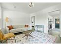 Bright and airy living room with neutral colors, a vintage-style table, and a view into the kitchen at 2122 Commander Rd, North Charleston, SC 29405