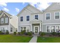 Well-manicured lawn leads up to this charming two-story townhome at 258 Godwit Dr, Summerville, SC 29486
