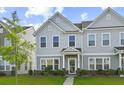 Well-manicured lawn and landscaping lead up to this charming two-story townhome at 258 Godwit Dr, Summerville, SC 29486