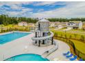 Resort-style pool featuring a water slide with a lifeguard chair alongside multiple lounge chairs at 290 Watersglen Dr, Summerville, SC 29486