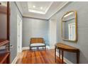 Elegant hallway featuring a vintage bench, wooden table, striking mirror, and a sophisticated gray textured wall at 341 Cooper River Dr, Mount Pleasant, SC 29464