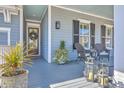 Inviting front porch with comfortable seating and stylish lanterns, perfect for relaxing outdoors at 3697 Stamler Ct, Mount Pleasant, SC 29466