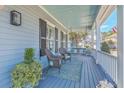 Cozy front porch with blue accents, comfortable seating, and serene atmosphere for relaxation at 3697 Stamler Ct, Mount Pleasant, SC 29466