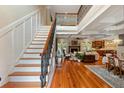 Elegant foyer with hardwood floors, staircase, and open view into the living room and kitchen area at 4217 Sawgrass Dr, Charleston, SC 29420