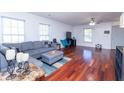 Spacious living room with hardwood floors, large windows, and comfortable gray sectional sofa at 5007 Ballantine Dr, Summerville, SC 29485