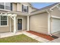 Close up on the front door and covered porch with tasteful decorations and a welcoming sign at 708 Professor Dr, Ladson, SC 29456