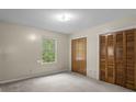Cozy bedroom features neutral carpet, bright window, and a double closet at 7920 Parklane Ct # 608, North Charleston, SC 29418