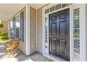 Close-up of a classic black front door framed by sidelights, showcasing the home's inviting entrance at 8961 N Red Maple Cir, Summerville, SC 29485
