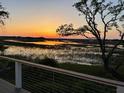 Picturesque marsh view at sunset from balcony with vibrant colors reflecting on water at 9 Marsh Island Ln, Isle of Palms, SC 29451