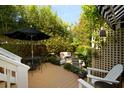 Private backyard featuring a deck, lush greenery, and comfortable seating area at 1012 Ashley Ave, Charleston, SC 29403