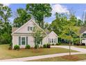 Beautifully landscaped home with lush lawn, mature trees, and a welcoming walkway to the front door at 1160 Old Field Dr, Summerville, SC 29483