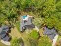 Aerial view of a home with a private backyard pool and deck, surrounded by mature trees at 118 Elery Ter, Summerville, SC 29485
