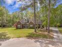 Attractive brick home surrounded by mature trees and a lush lawn, offering curb appeal at 118 Elery Ter, Summerville, SC 29485