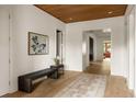 Foyer featuring hardwood floors, a wooden ceiling, statement artwork, and a bench for comfortable entry at 1412 Jackson St, Mount Pleasant, SC 29464