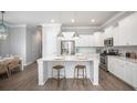 Bright, modern kitchen with white cabinets, stainless steel appliances, and a large center island with seating at 1431 Clay Field Trl, Summerville, SC 29485