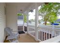 Cozy front porch with gray Adirondack chair and view of a quiet neighborhood street at 144 Jupiter Ln, Summerville, SC 29483