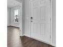Bright entryway featuring a white front door, gray walls, and wood flooring flowing into an open space at 145 Threaded Fern St, Summerville, SC 29485