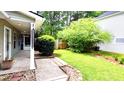 A spacious backyard with lush greenery, a screened in porch, and a manicured yard at 148 Jupiter Ln, Summerville, SC 29483