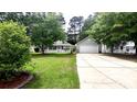 Charming single-Gathering home with well-manicured lawn, and a two-car garage at 148 Jupiter Ln, Summerville, SC 29483