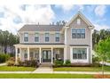 Inviting two-story home with a charming covered porch, landscaped front yard, and classic architectural details at 184 Clearblue Loop, Summerville, SC 29486
