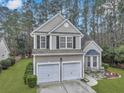 Charming two-story home featuring a two-car garage, front garden, and landscaped yard at 2004 Hammond Dr, Mount Pleasant, SC 29466