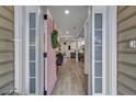 Inviting foyer with a pink front door, leading to an open-concept living space with modern floors at 2004 Hammond Dr, Mount Pleasant, SC 29466