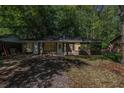Beautiful single-story brick home surrounded by mature trees, offering a serene and private setting at 203 Elliott Dr, Ladson, SC 29456