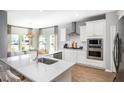 Modern kitchen with white cabinets, stainless steel appliances, granite countertops, and an eat-in island at 257 Camellia Bloom Dr, Moncks Corner, SC 29461