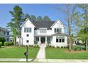 Charming two-story home with lush green lawn, trees, and inviting front porch at 2805 Stay Sail Way, Mount Pleasant, SC 29466