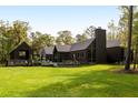 Expansive backyard with well-manicured lawn and sophisticated modern home with pool at 2885 Plow Ground Rd, Johns Island, SC 29455