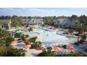 Resort-style community pool with slides, ample seating and umbrellas, surrounded by lush landscaping and multiple buildings at 299 Citrus Dr, Summerville, SC 29486