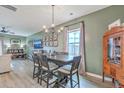 Inviting dining room with a large table, decorative chandelier, and ample natural light at 302 Fox Gap Rd, Summerville, SC 29486