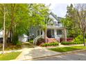 Charming two-story home with a detached garage, front porch and mature trees at 3030 Baltimore St, Charleston, SC 29492